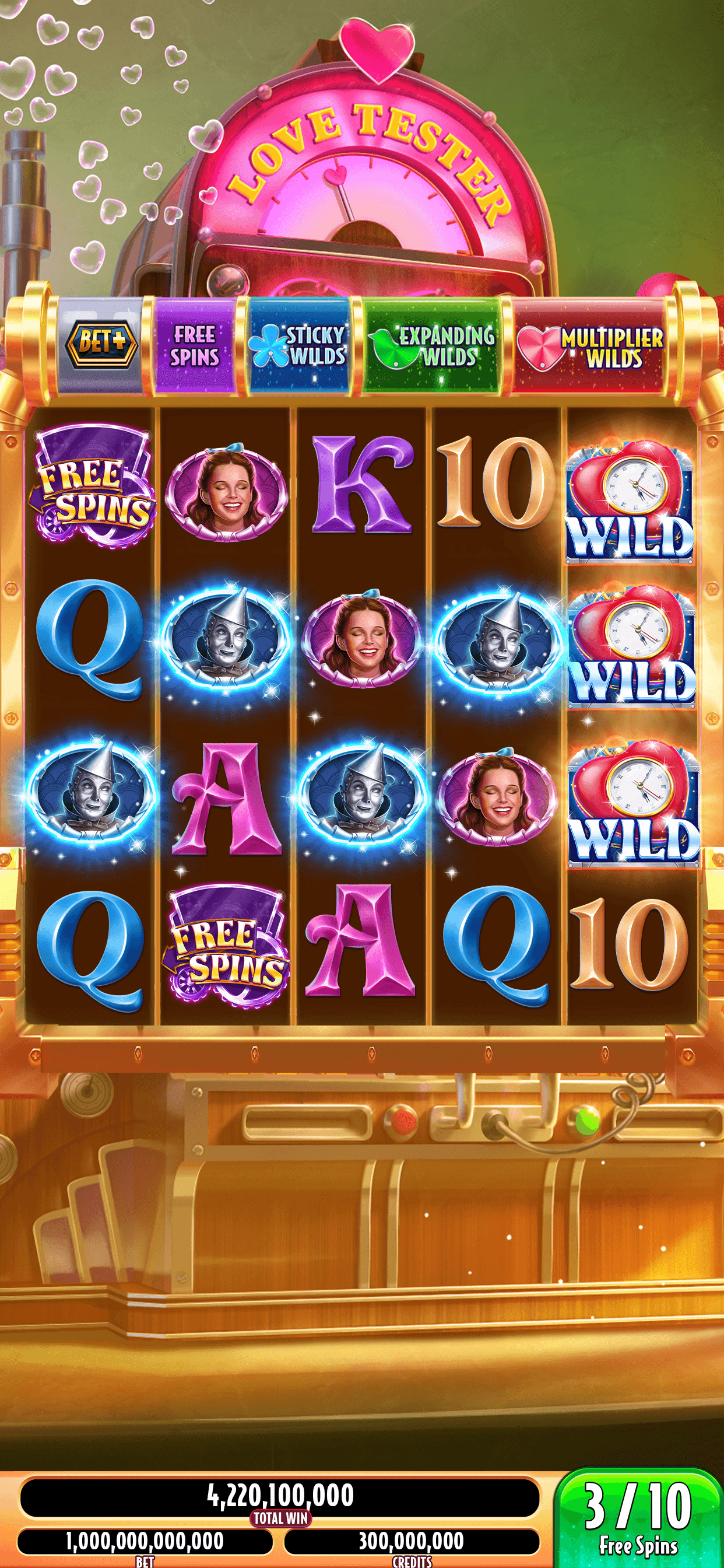 A Wizard of Oz Slots machine with a feature bar listing free spins, sticky wilds, expanding wilds and multiplier wilds above the reels