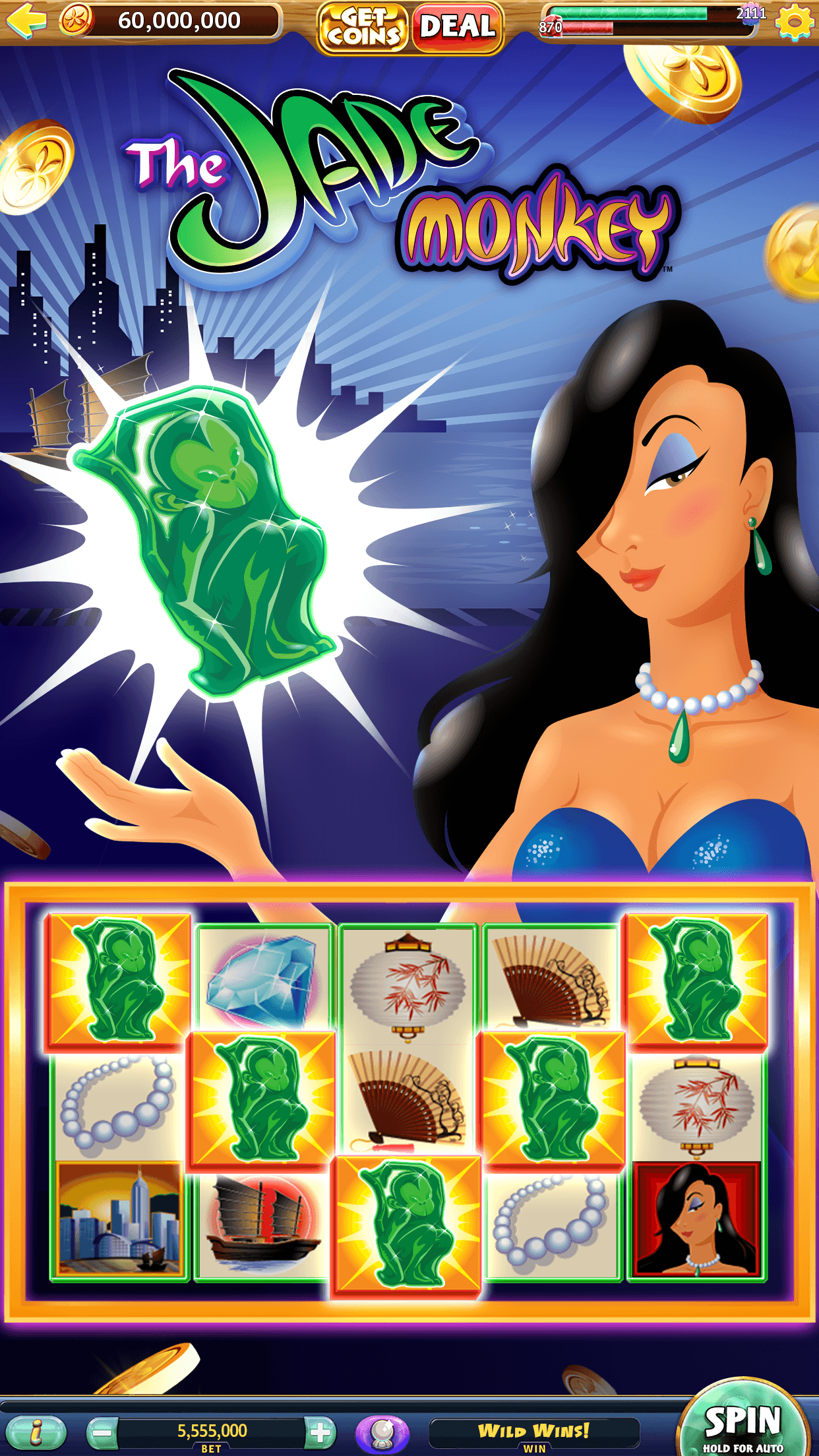 The Jade Monkey slot in Gold Fish Casino Slots in portrait view, a woman holding a glowing green monkey figurine above reels of jade monkeys, fans, lanterns and pearls, with a Coin balance of 60,000,000 at the top and a bet of 5,555,000 at the bottom