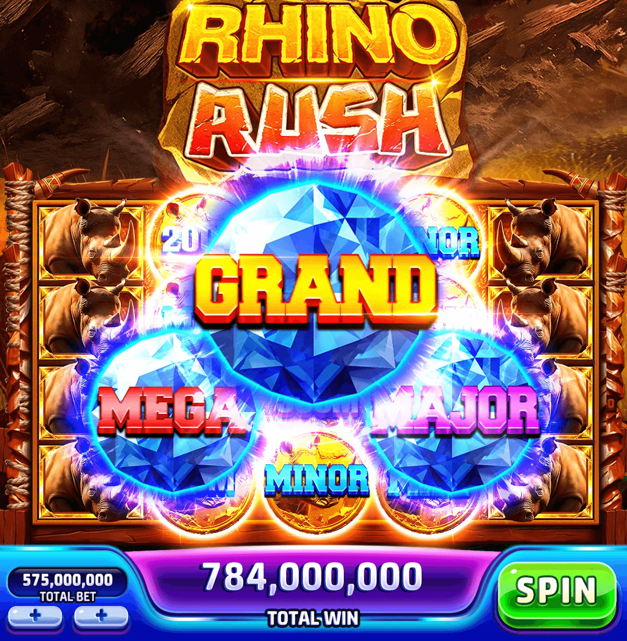The Rhino Rush machine in Jackpotland, blue gems marked Grand, Mega, Major and Minor bursting over reels of rhinos, with a total bet of 575,000,000, a total win of 784,000,000 and the Spin button along the bottom