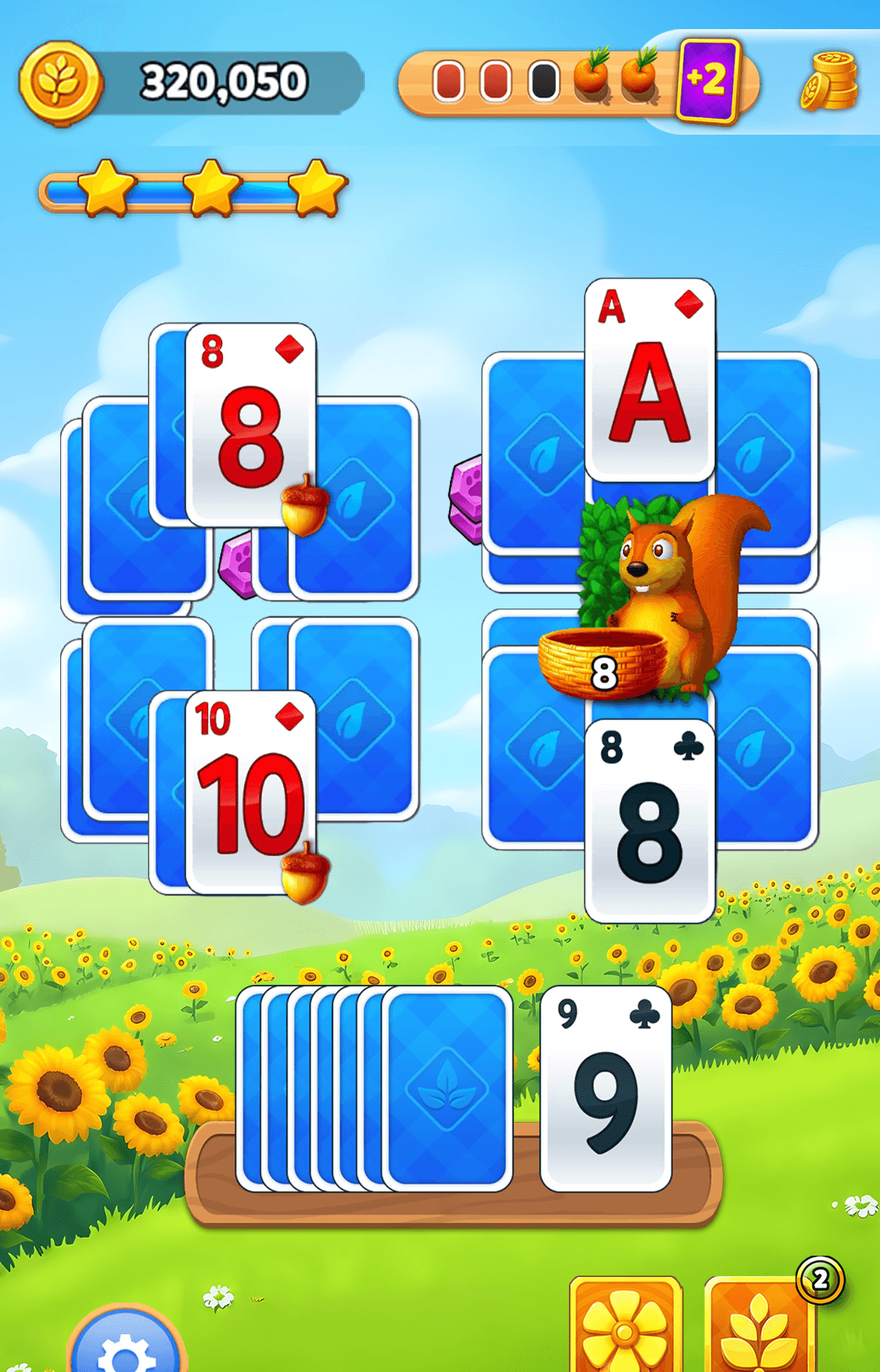 A Solitaire Grand Harvest level with playing cards laid out above a draw pile and a wild card booster